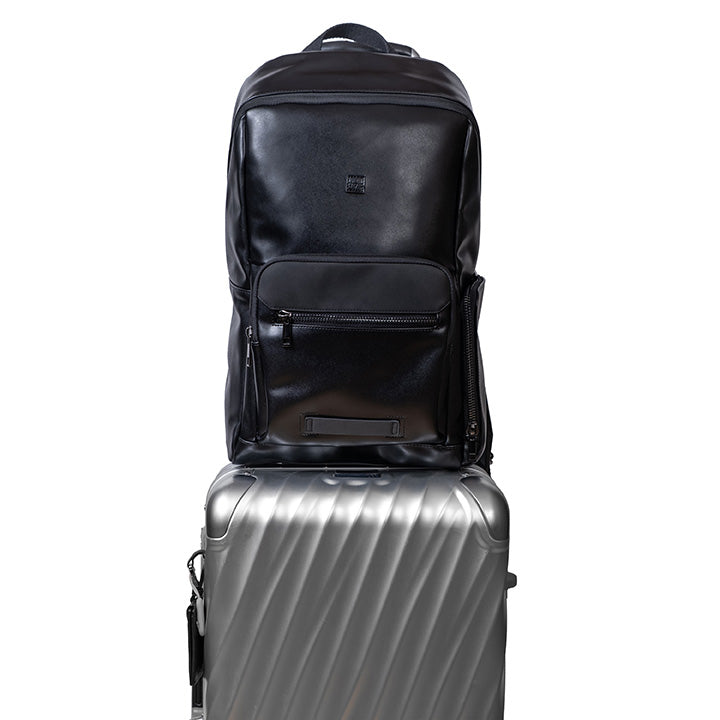 Black backpack on top of a suitcase