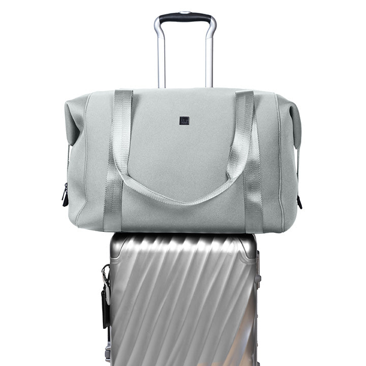 duffel bag on top of a suitcase